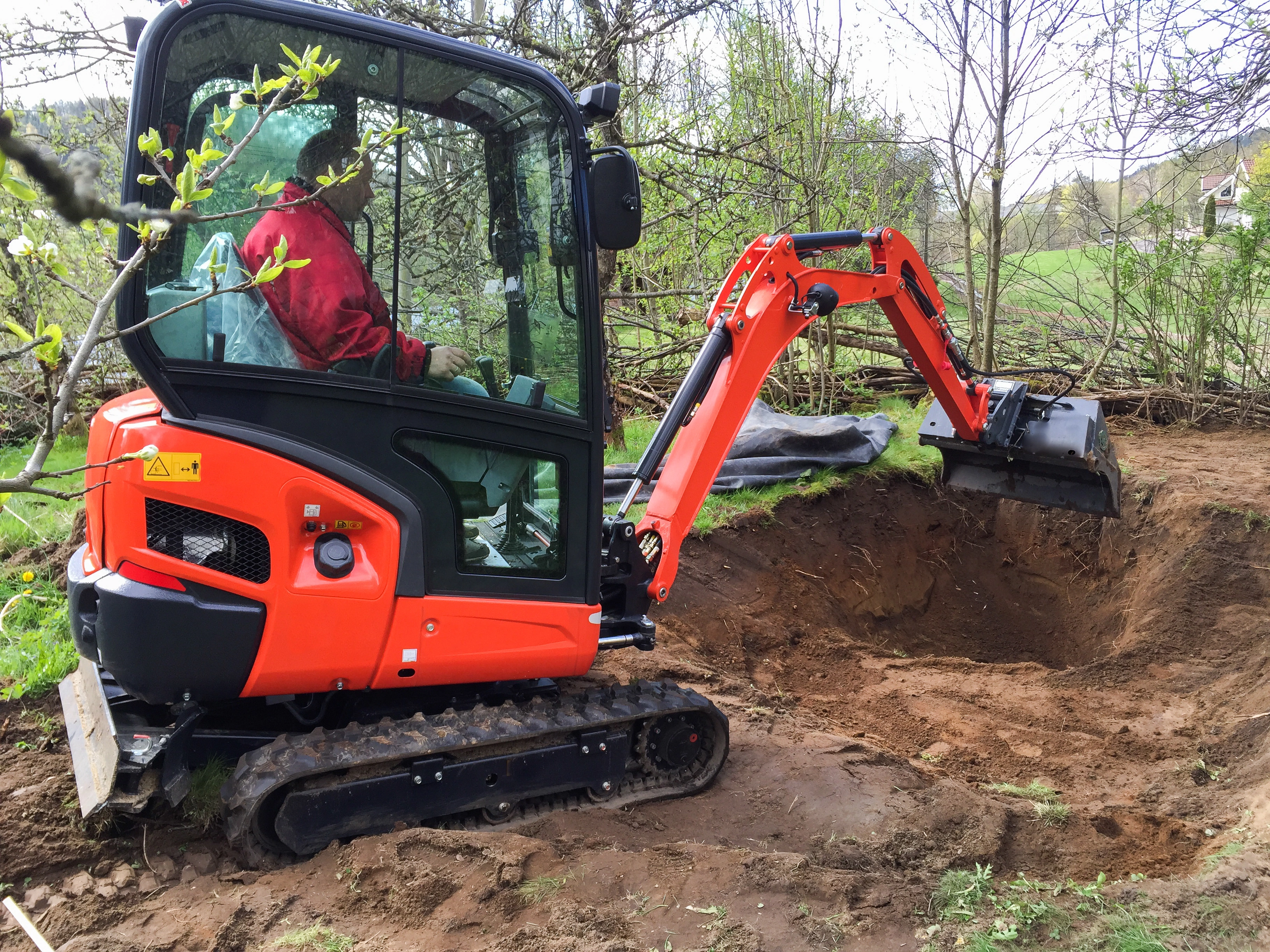 excavator removing a stump